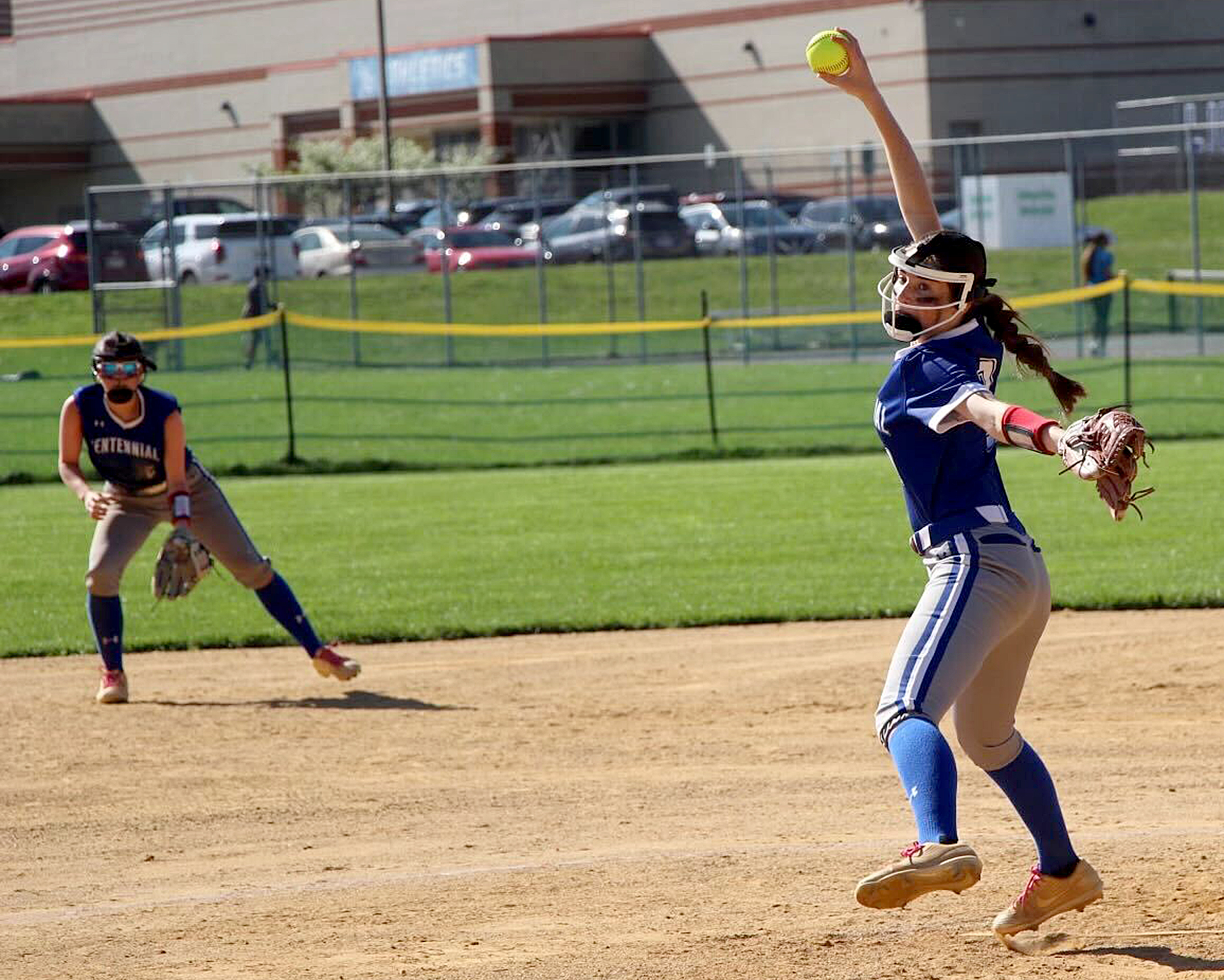 Centennial pitcher Lauren Jensen winds up to throw a pitch...