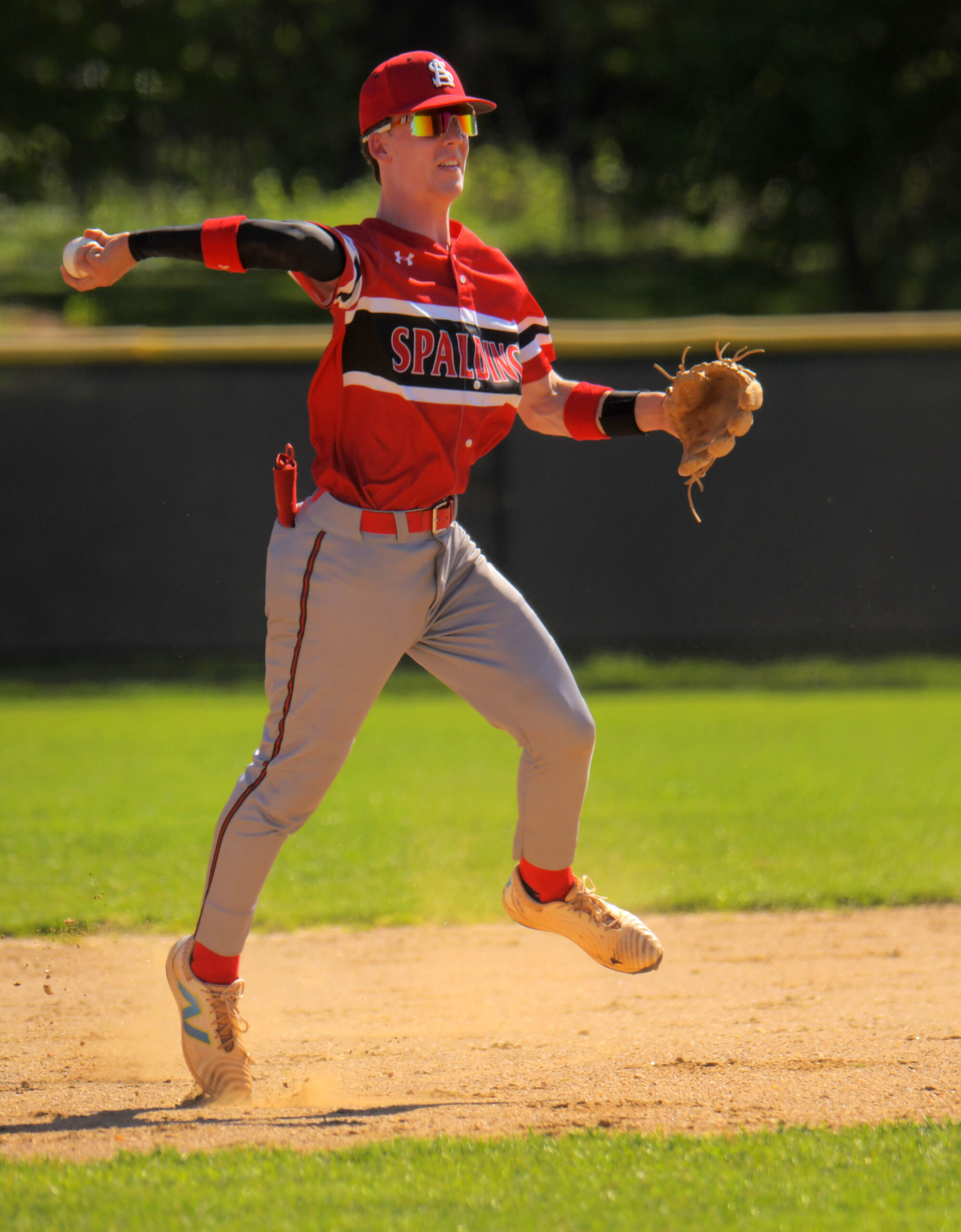 Archbishop Spalding Cavaliers shortstop Anthony Badillo throws across the diamond...
