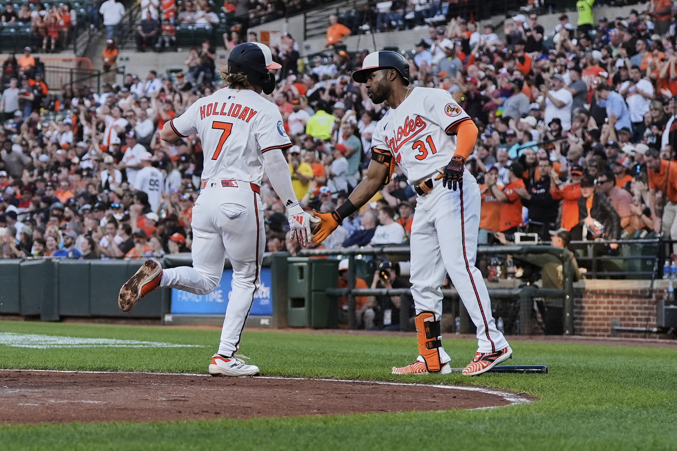 Baltimore Orioles' Jackson Holliday (7) celebrates with Cedric Mullins (31)...