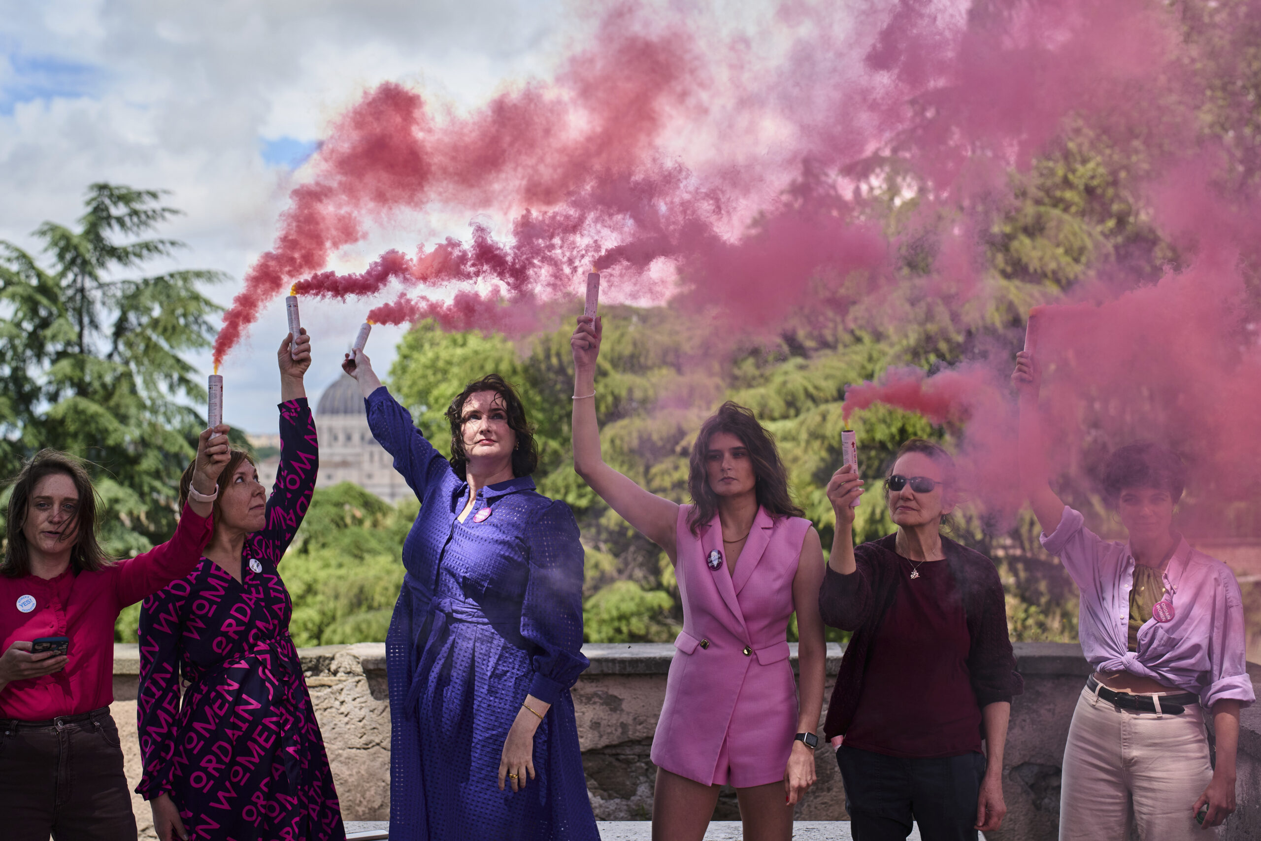 Activists from the Women's Ordination Conference release pink smoke