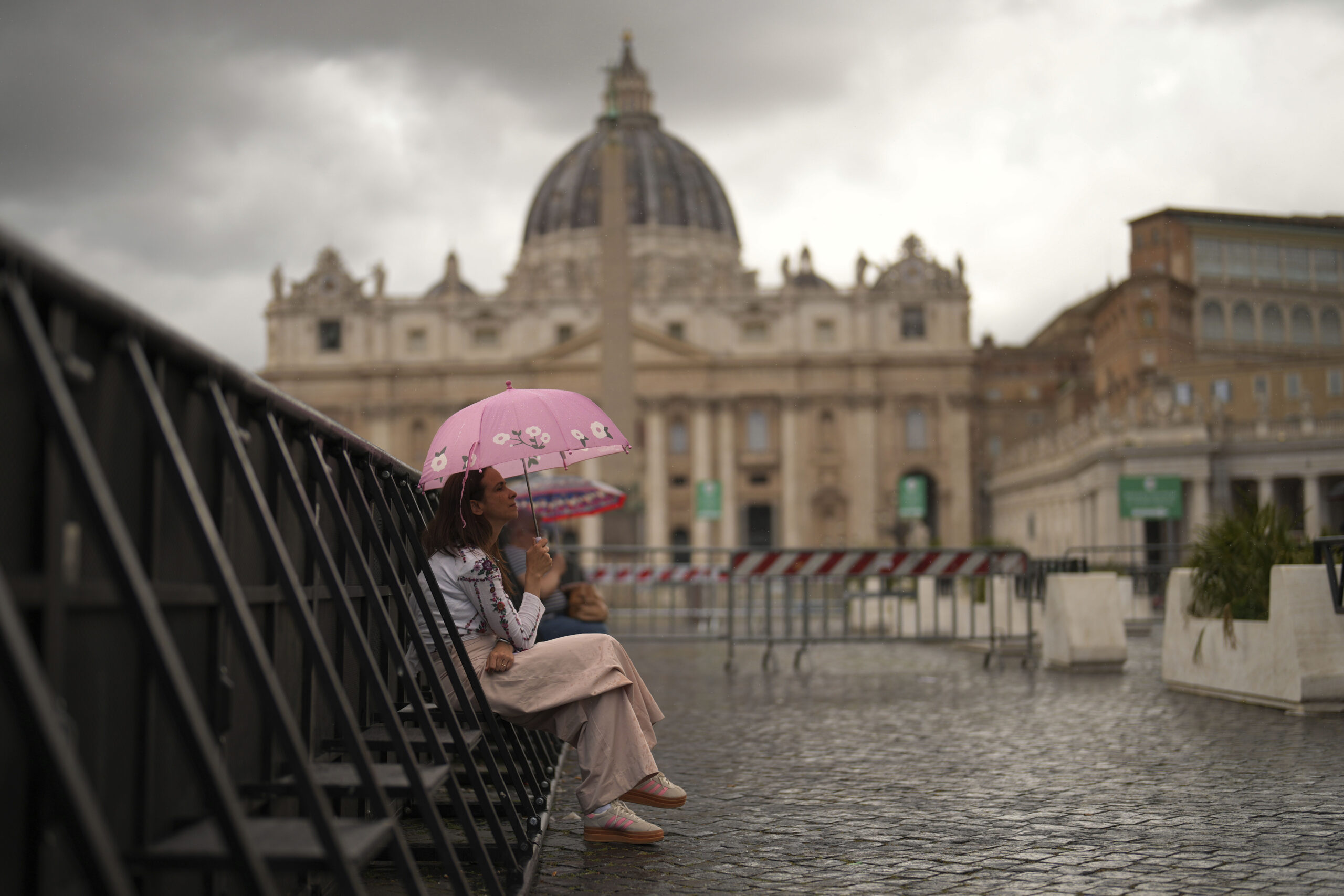 A woman shelters against the rain