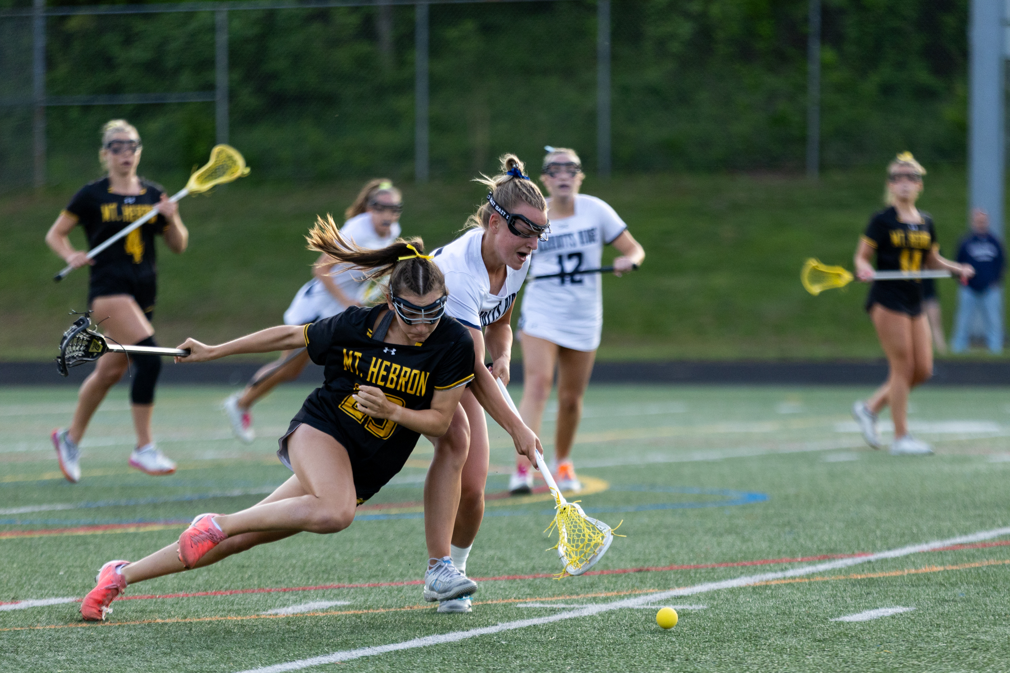 Mt. Hebron’s Maria Brogno trips while fighting for possession against...