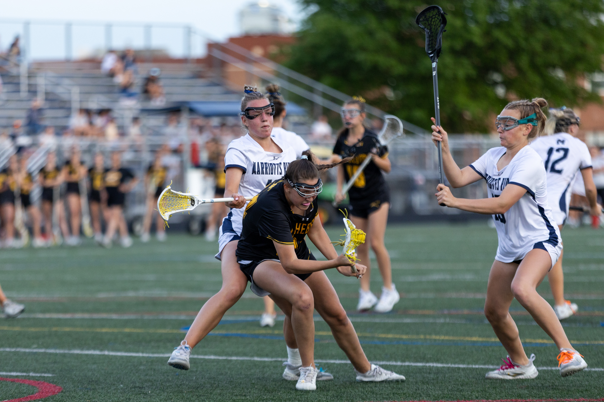 Mt. Hebron’s Taylor Shinskie is checked by Jenna Cratin during...