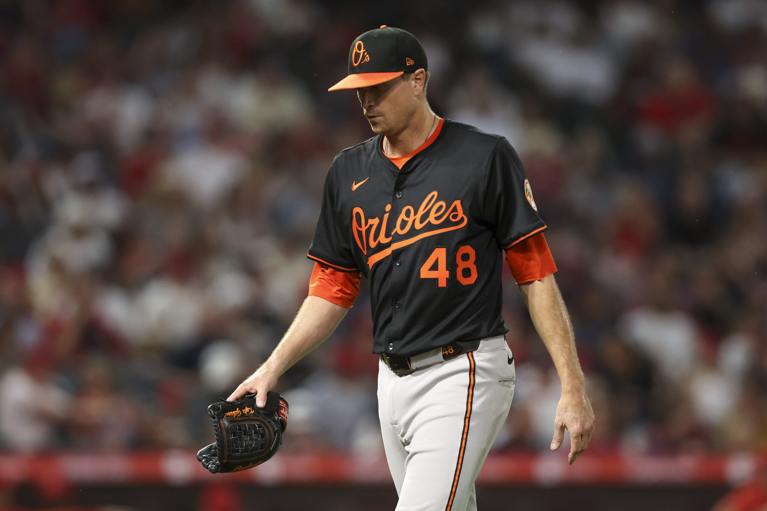 Orioles pitcher Kyle Gibson walks toward the dugout after being...