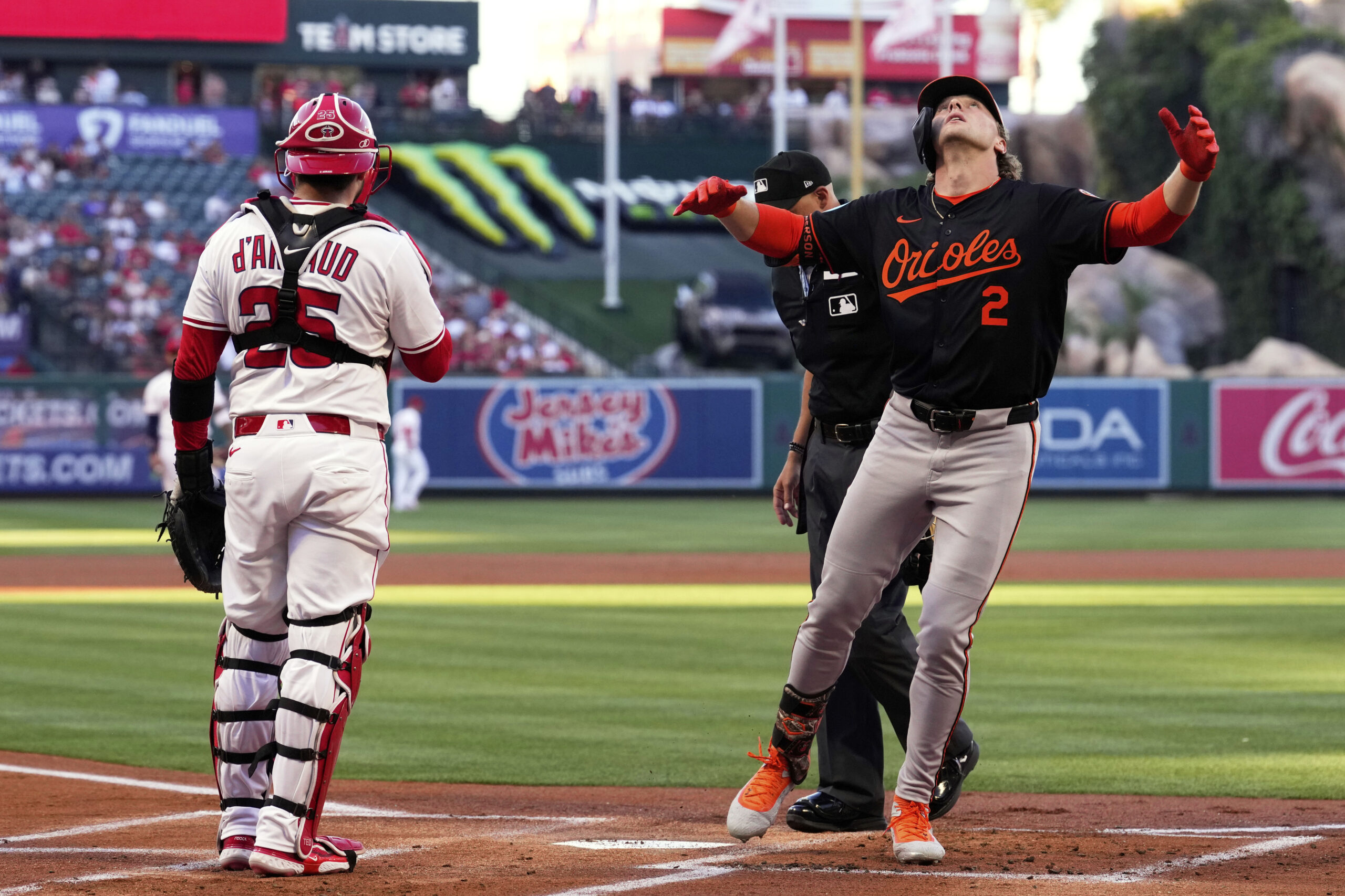 Baltimore Orioles' Gunnar Henderson, right, gestures as he scores after...