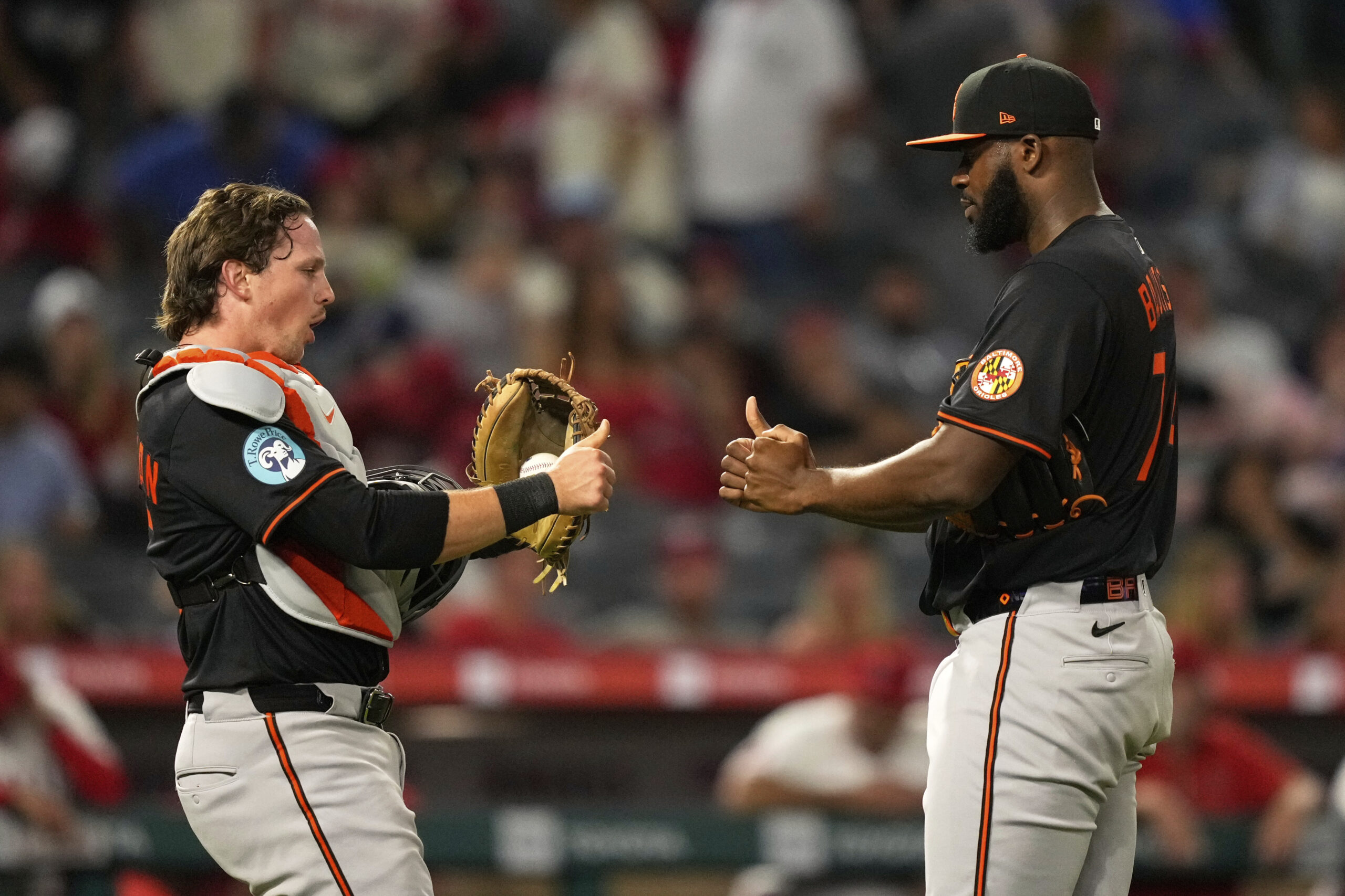 Baltimore Orioles catcher Adley Rutschman, left, and relief pitcher Felix...