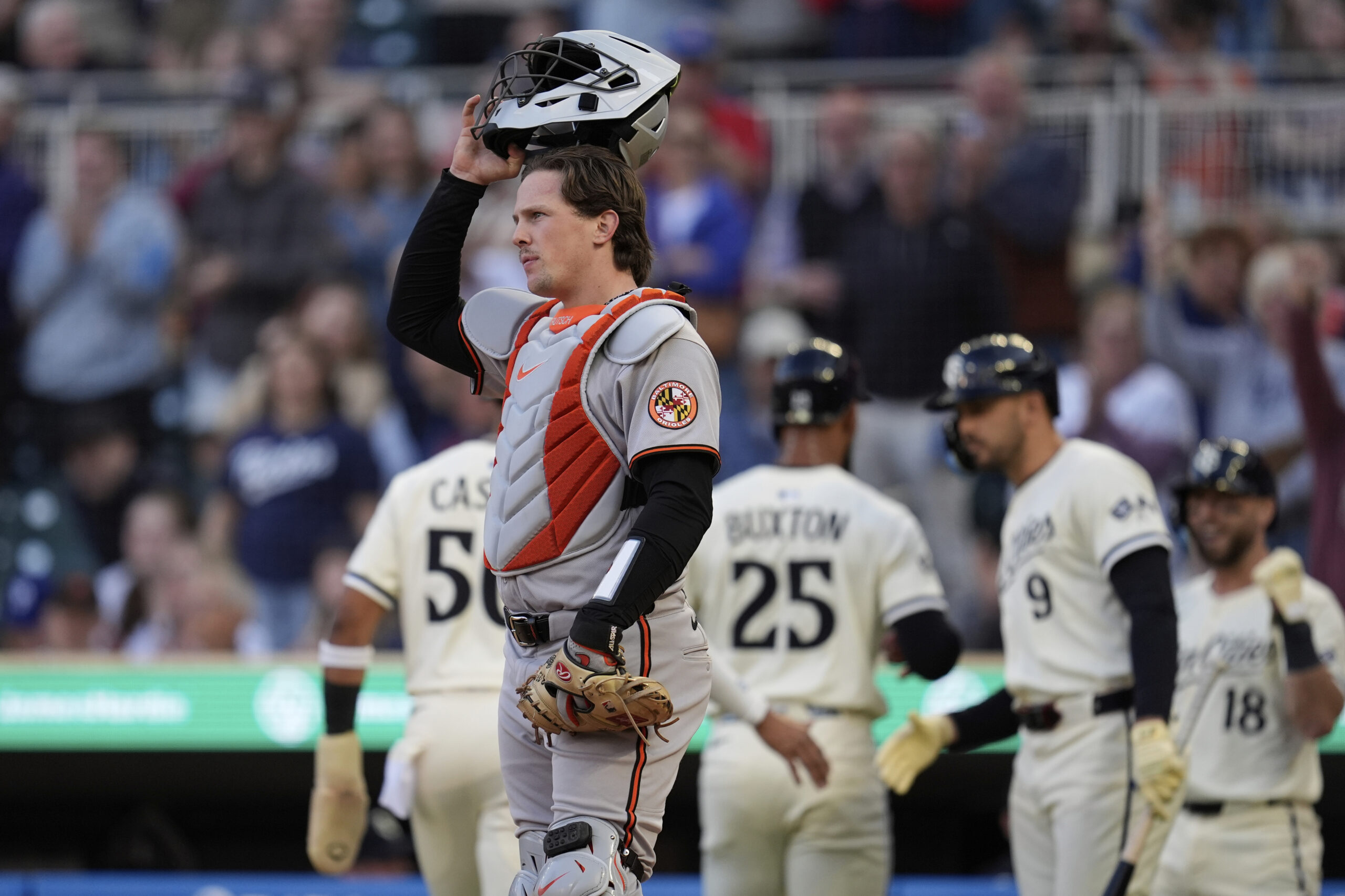 Orioles catcher Adley Rutschman looks on as the Twins' Byron...