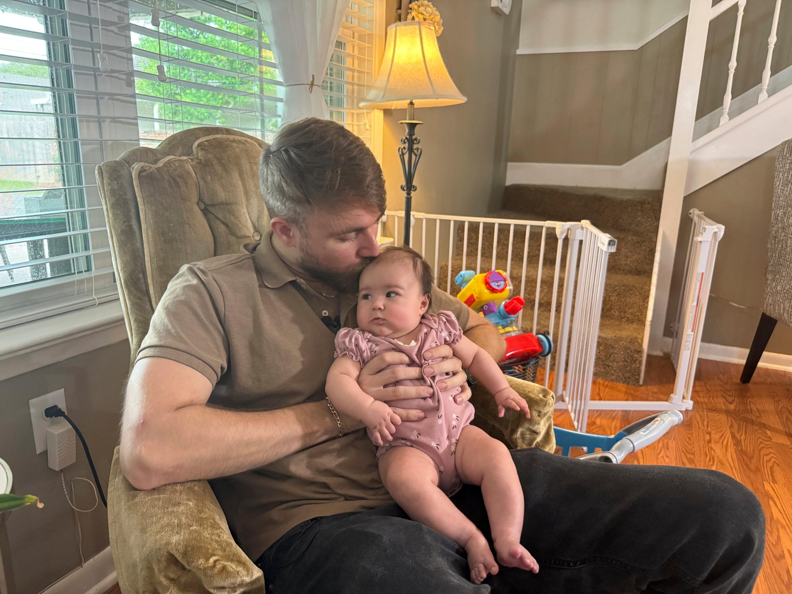 U.S. Marine Corps veteran Adrian Clouatre holds his 3-month-old daughter...