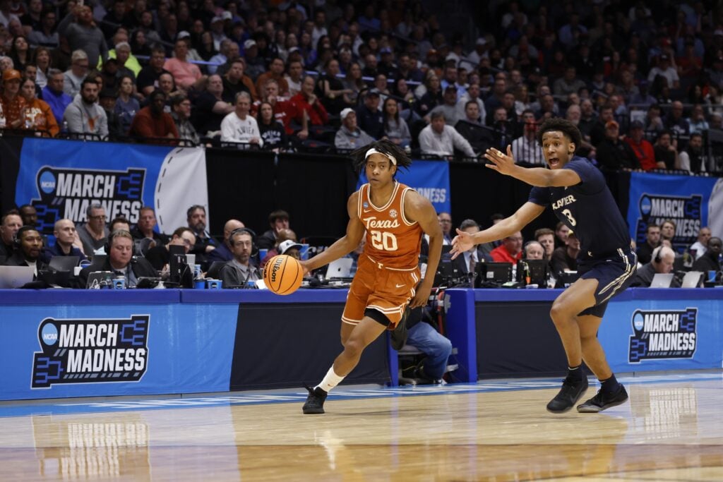 Mar 19, 2025; Dayton, OH, USA; Texas Longhorns guard Tre Johnson (20) dribbles pressured by Xavier Musketeers guard Dailyn Swain (3) in the first half at UD Arena. Mandatory Credit: Rick Osentoski-Imagn Images