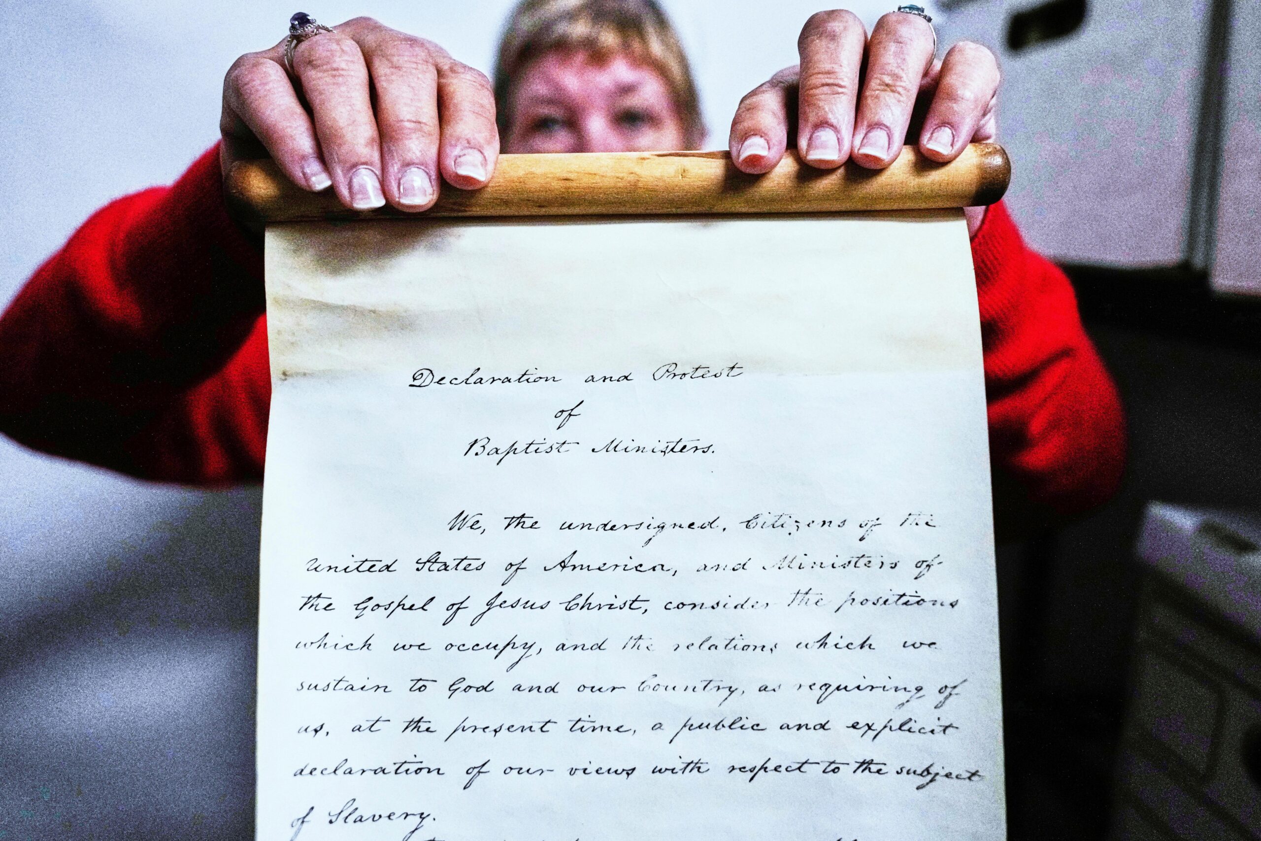 Historian Jennifer Cromack holds a recently found, 178-year-old anti-slavery scroll...