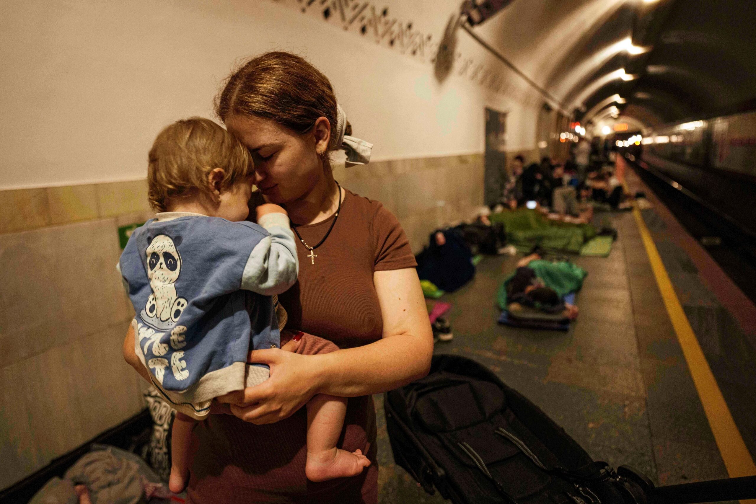 Oleksandra Umanets, 23, calms her 10-month-old son as they take...