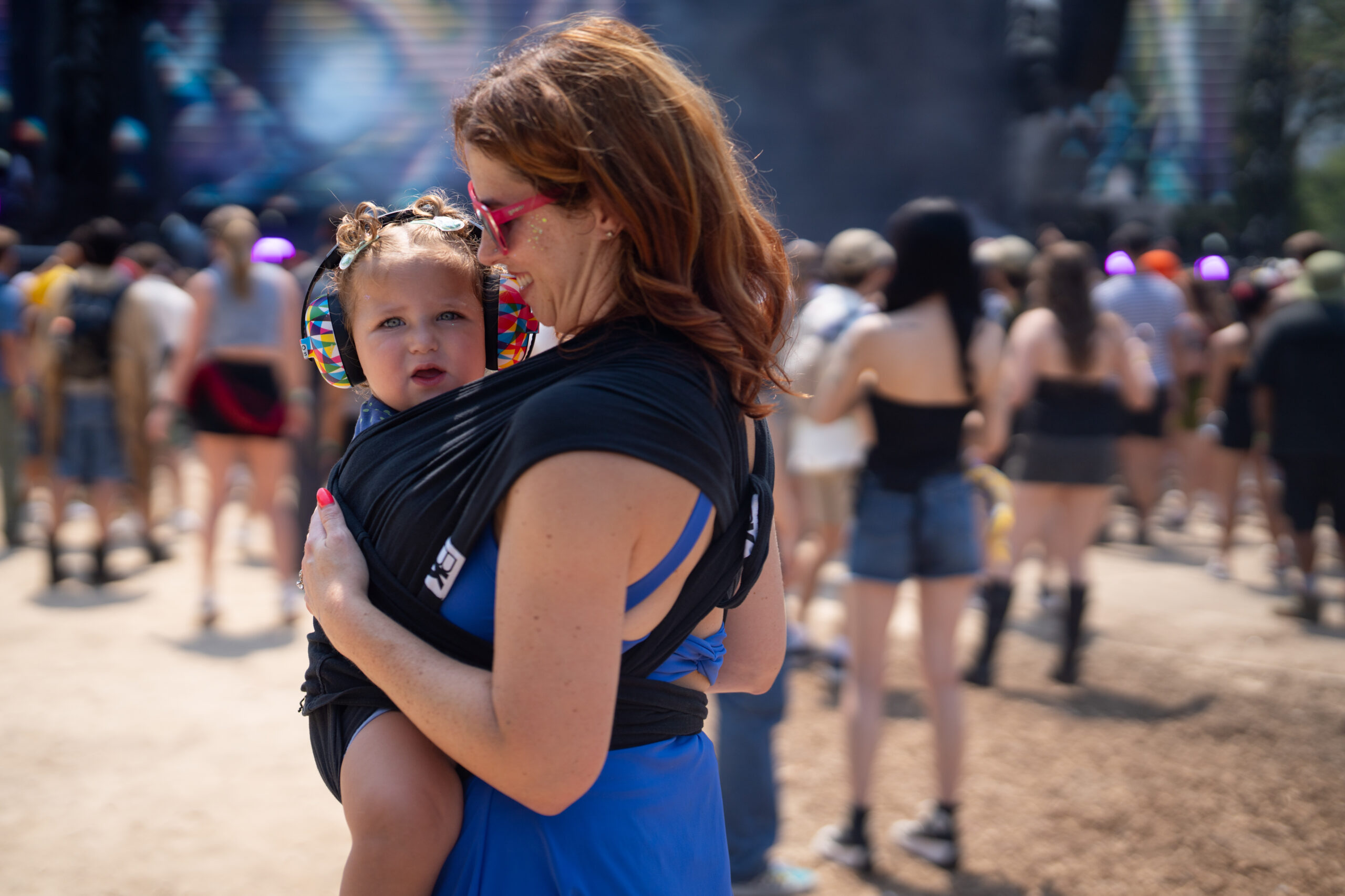 Jackie Garland, holds her daughter, Goldie Garland, 1, while listening...