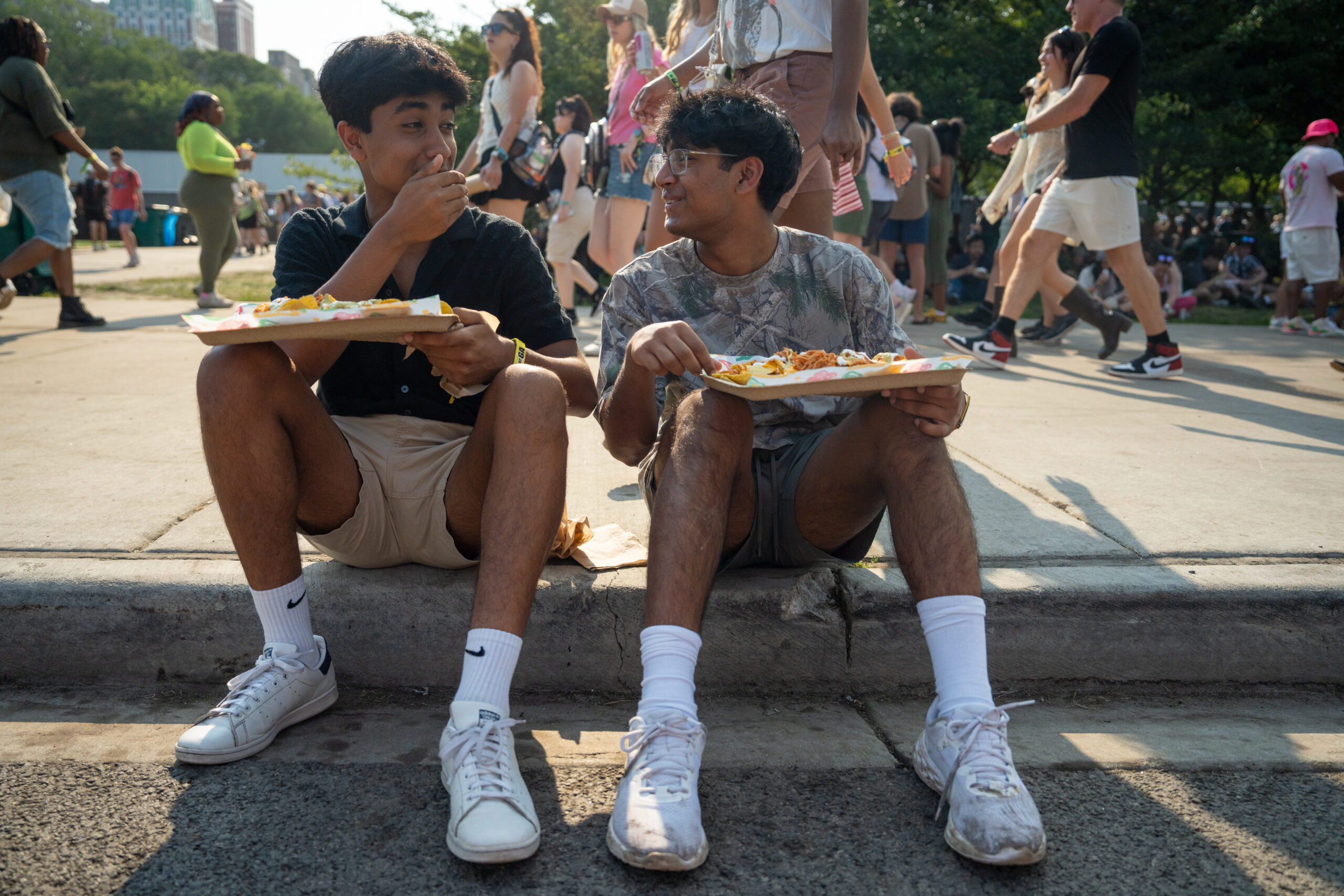 Liam Goyal, left, and Shalin Desai eat nachos during the...