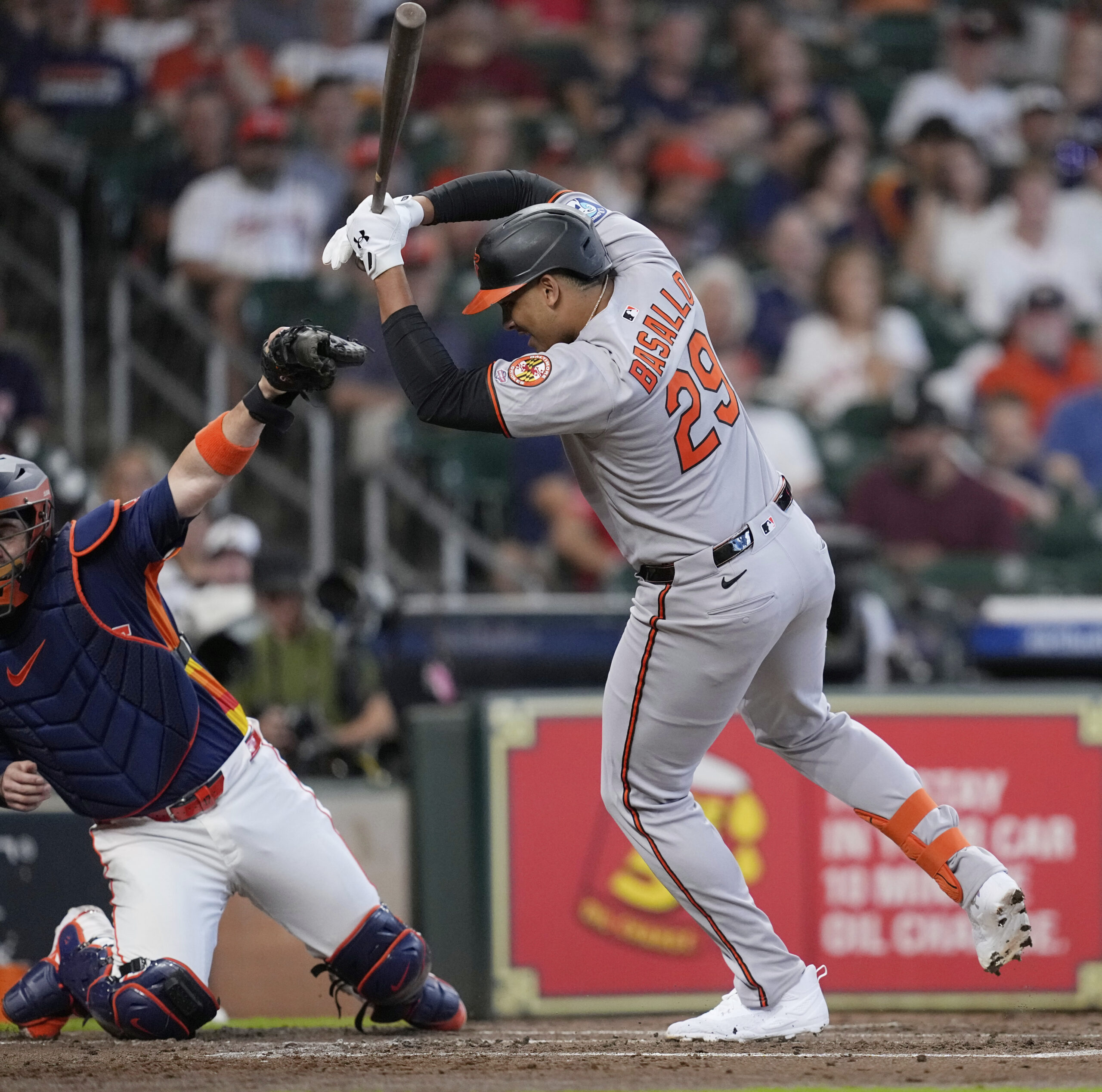 Baltimore Orioles' Samuel Basallo (29) reacts after being hit by...