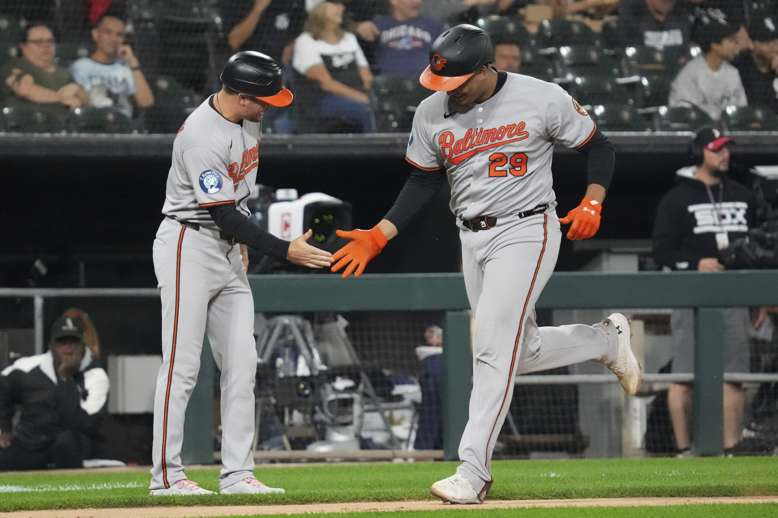 Baltimore Orioles' Samuel Basallo, right, celebrates with third base coach...