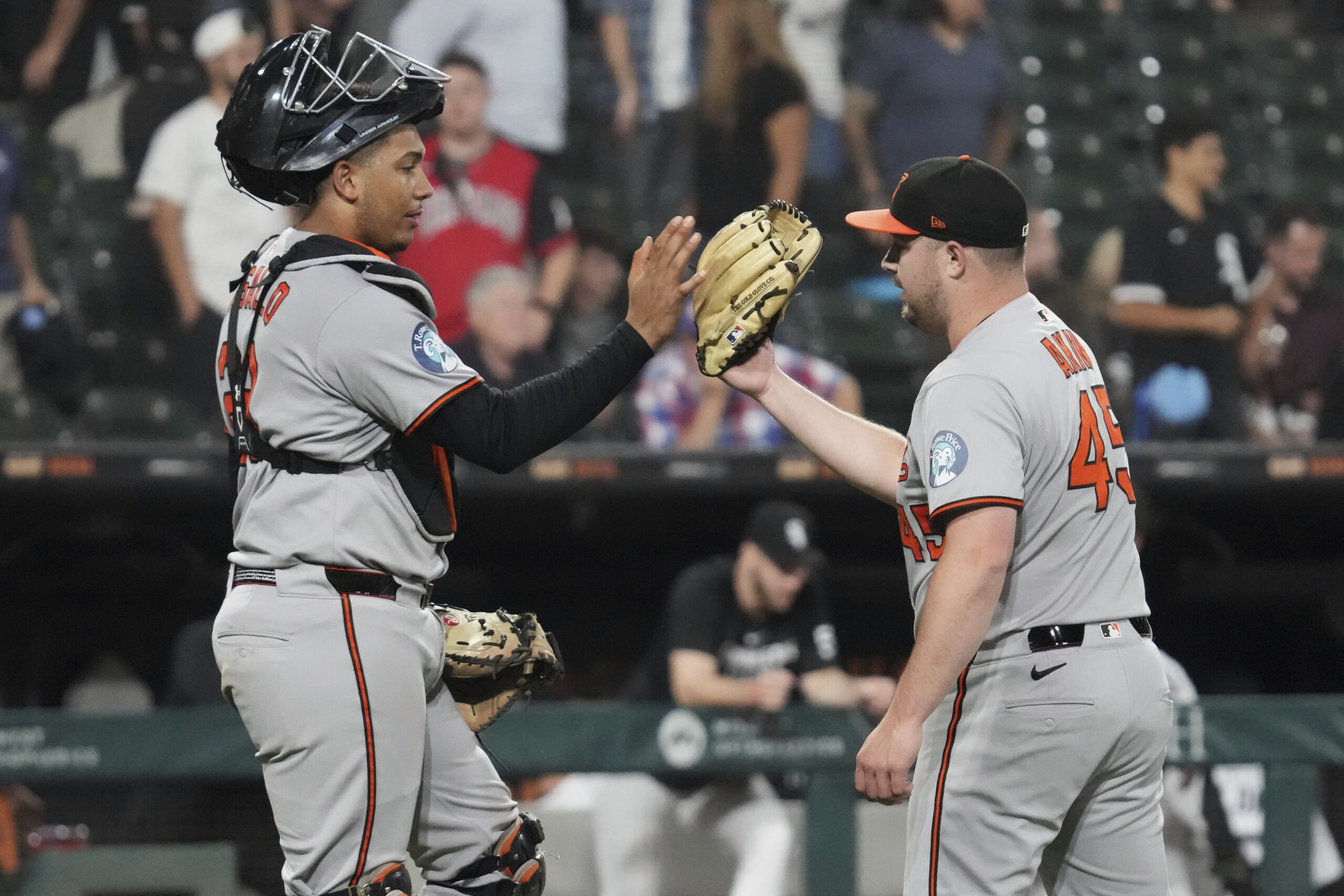 Baltimore Orioles catcher Samuel Basallo, left, celebrates with relief pitcher...