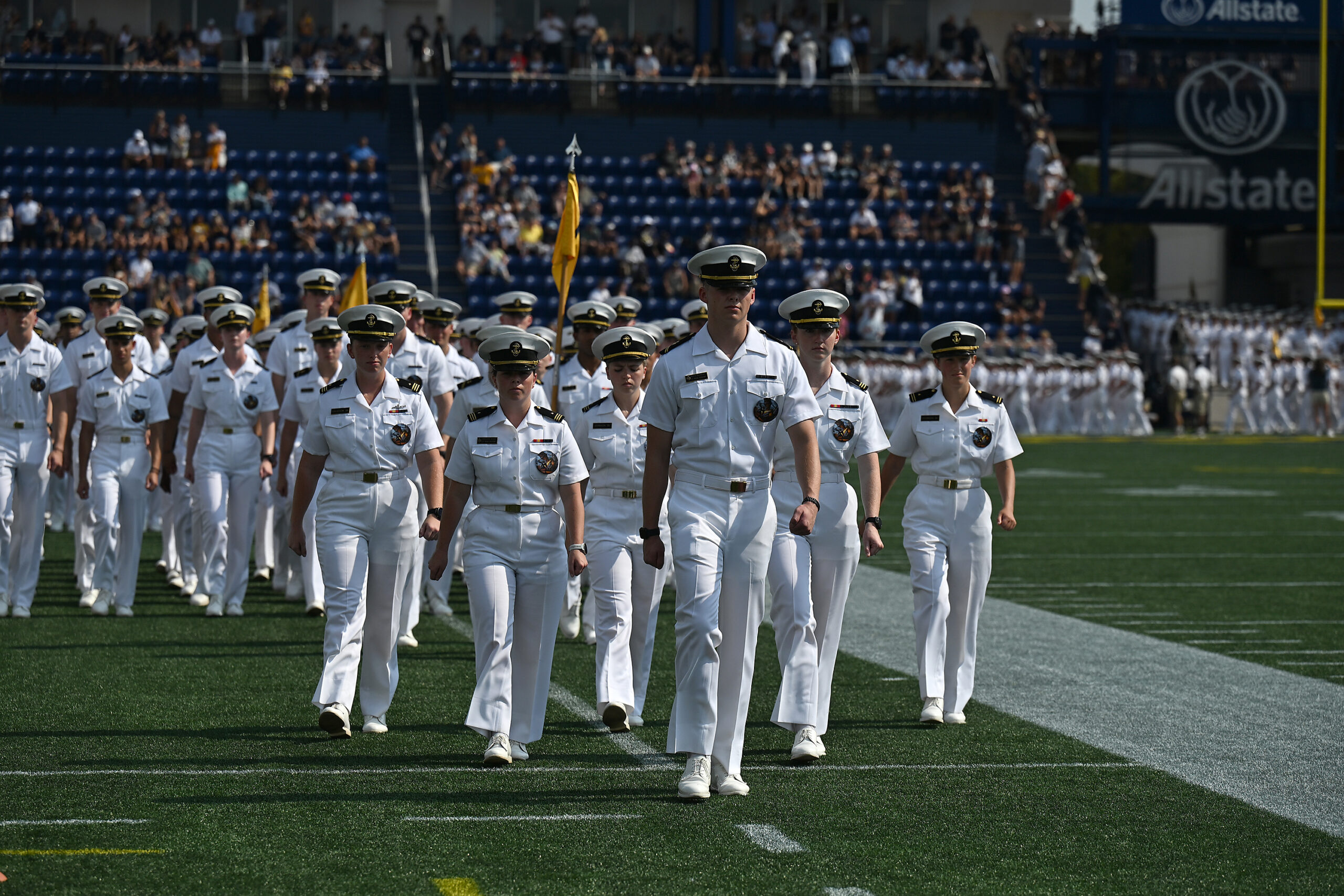 Midshipmen march into the stadium during the March-On. The Navy...