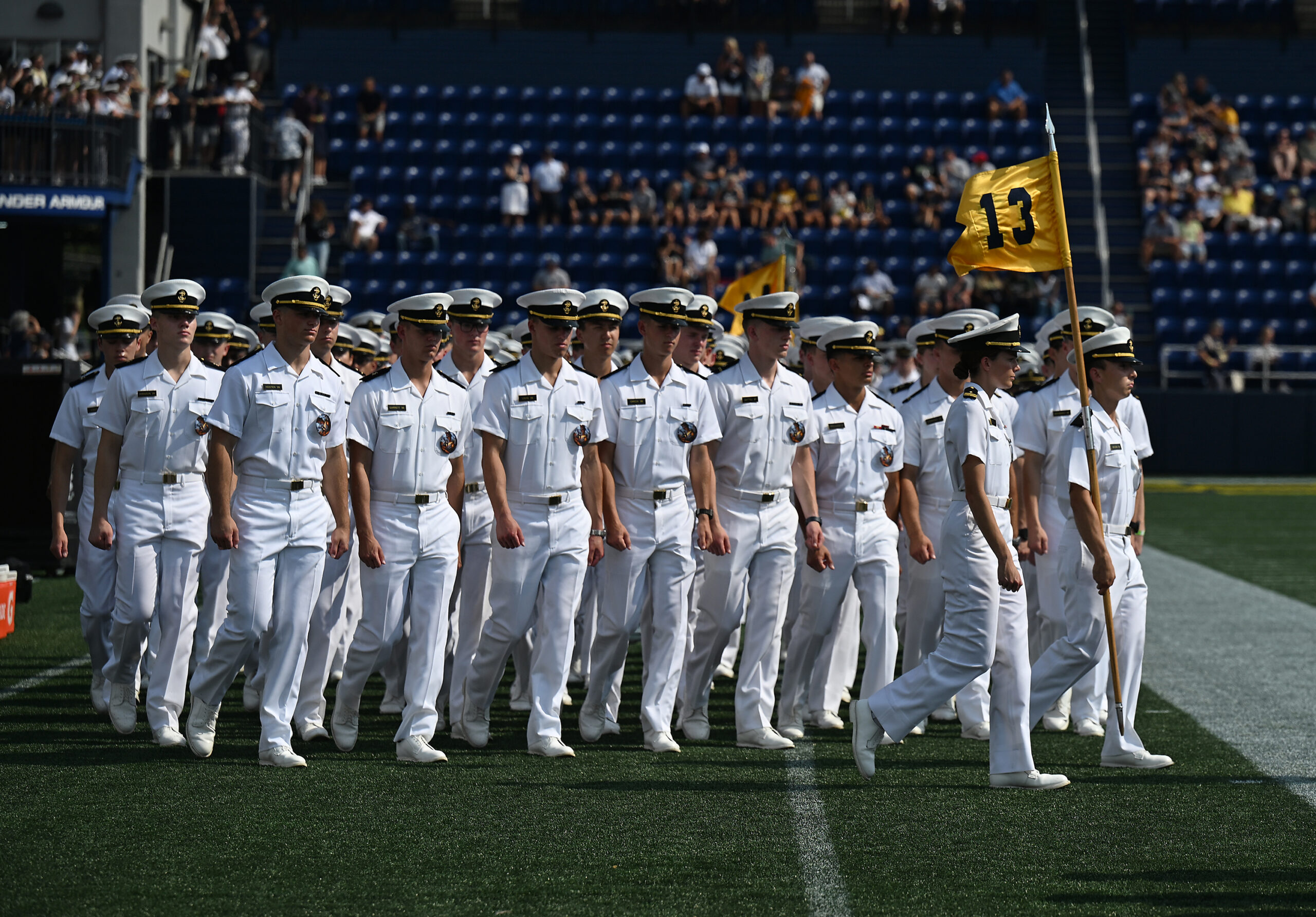 Midshipmen march into the stadium during the March-On. The Navy...