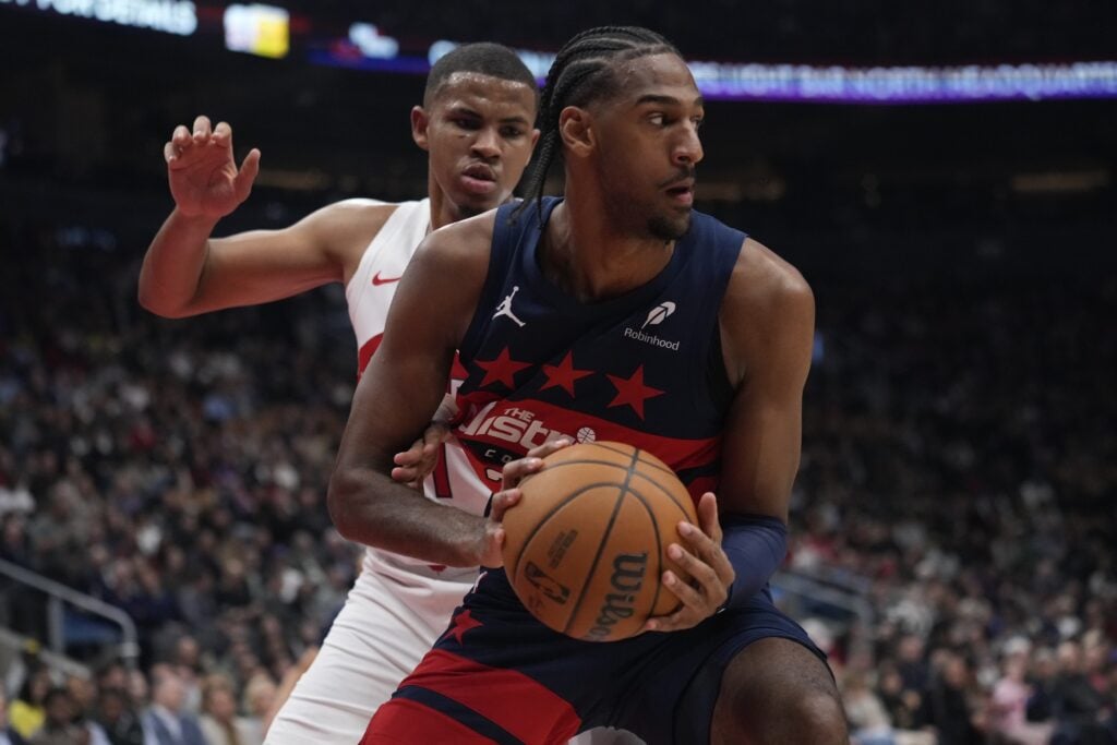 Washington Wizards center Alex Sarr (20) keeps the ball away from Toronto Raptors center Orlando Robinson (21) during the first half at Scotiabank Arena.