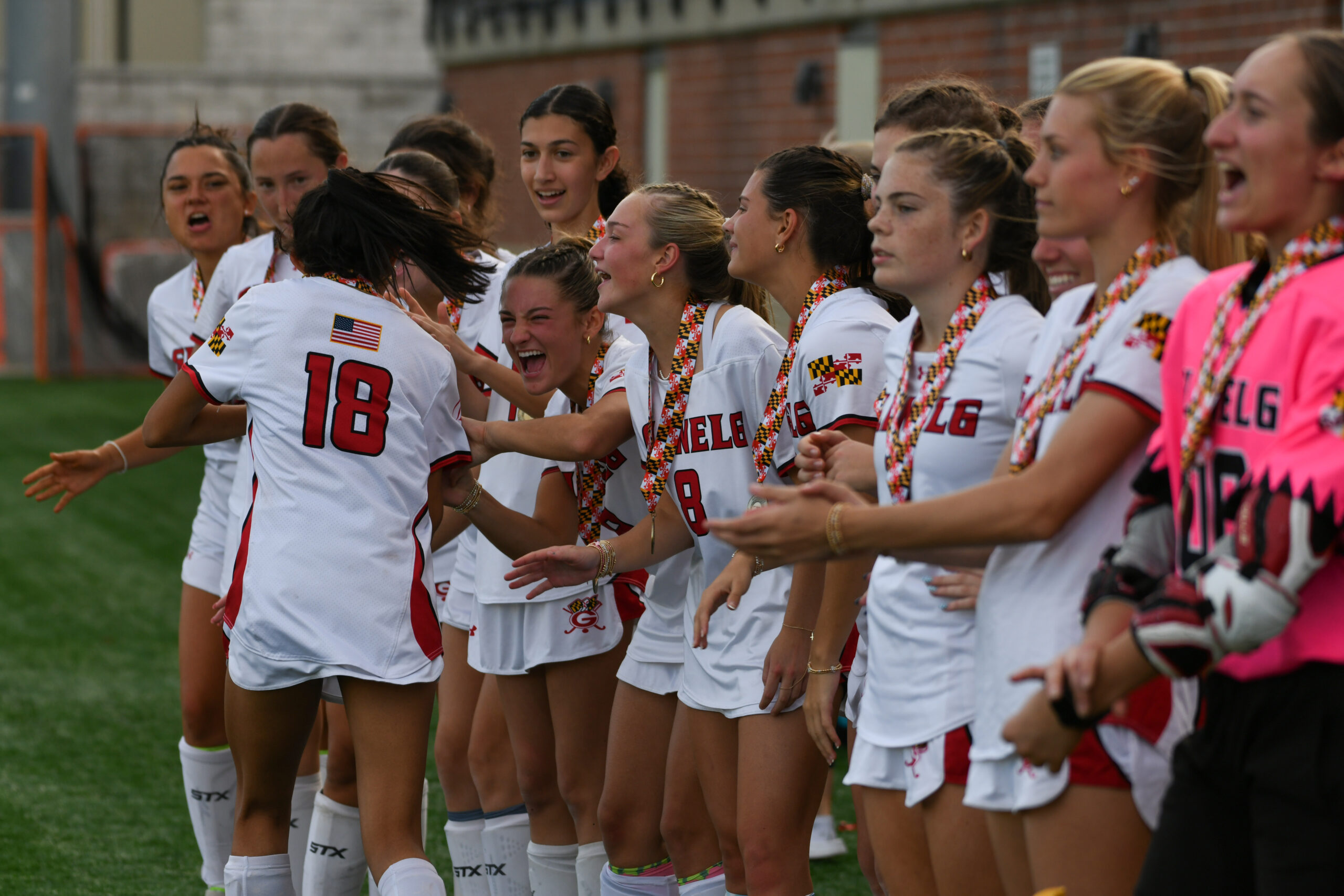 Glenelg players celebrate as they receive their championship medals following...