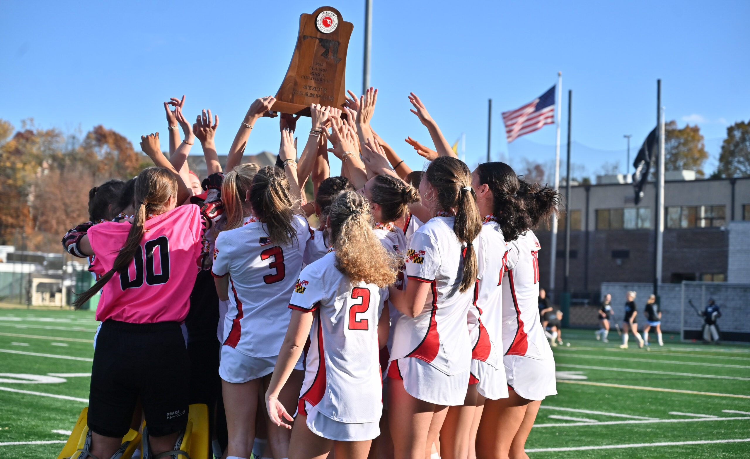Glenelg players celebrate with the championship trophy after beating Manchester...