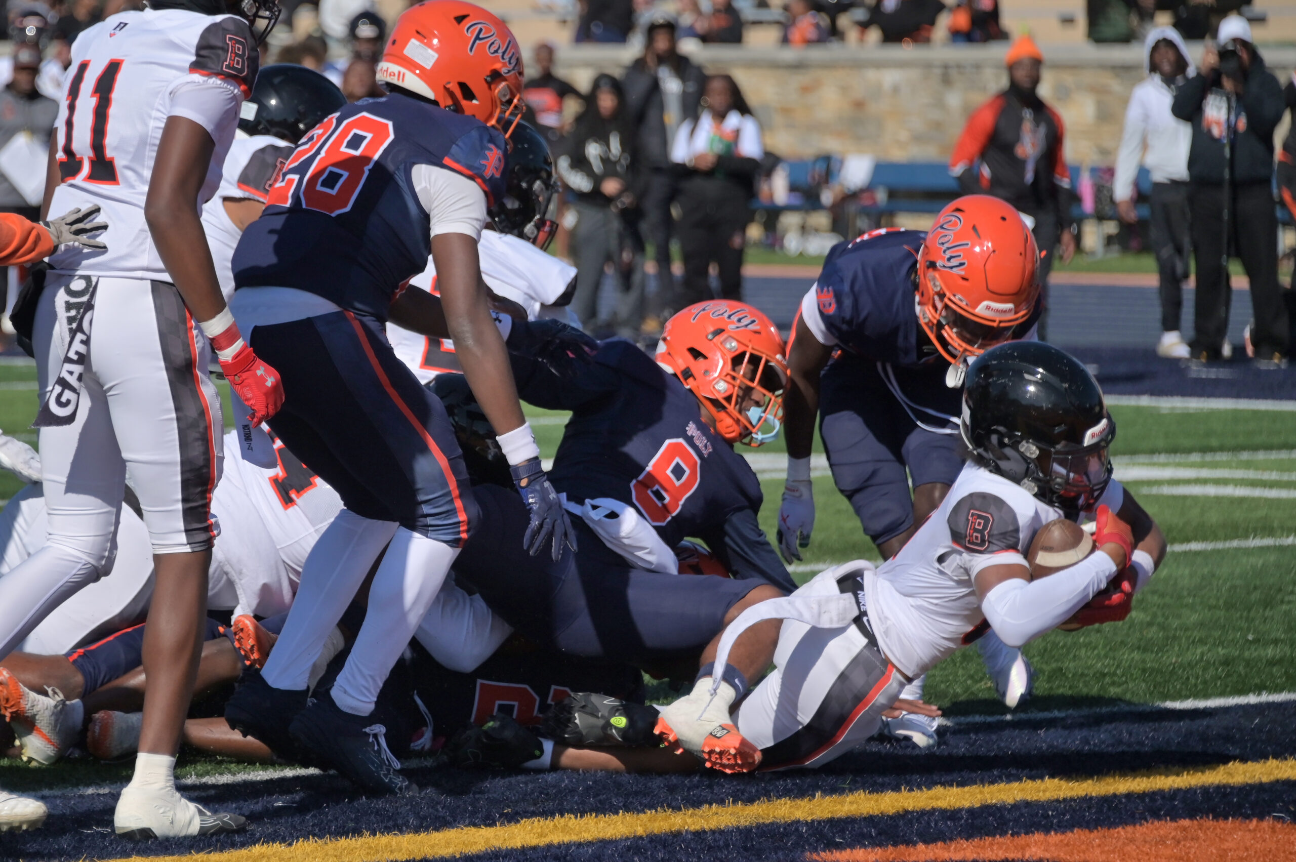 City’s Qamar Loise-baker scores a touchdown in the first half...