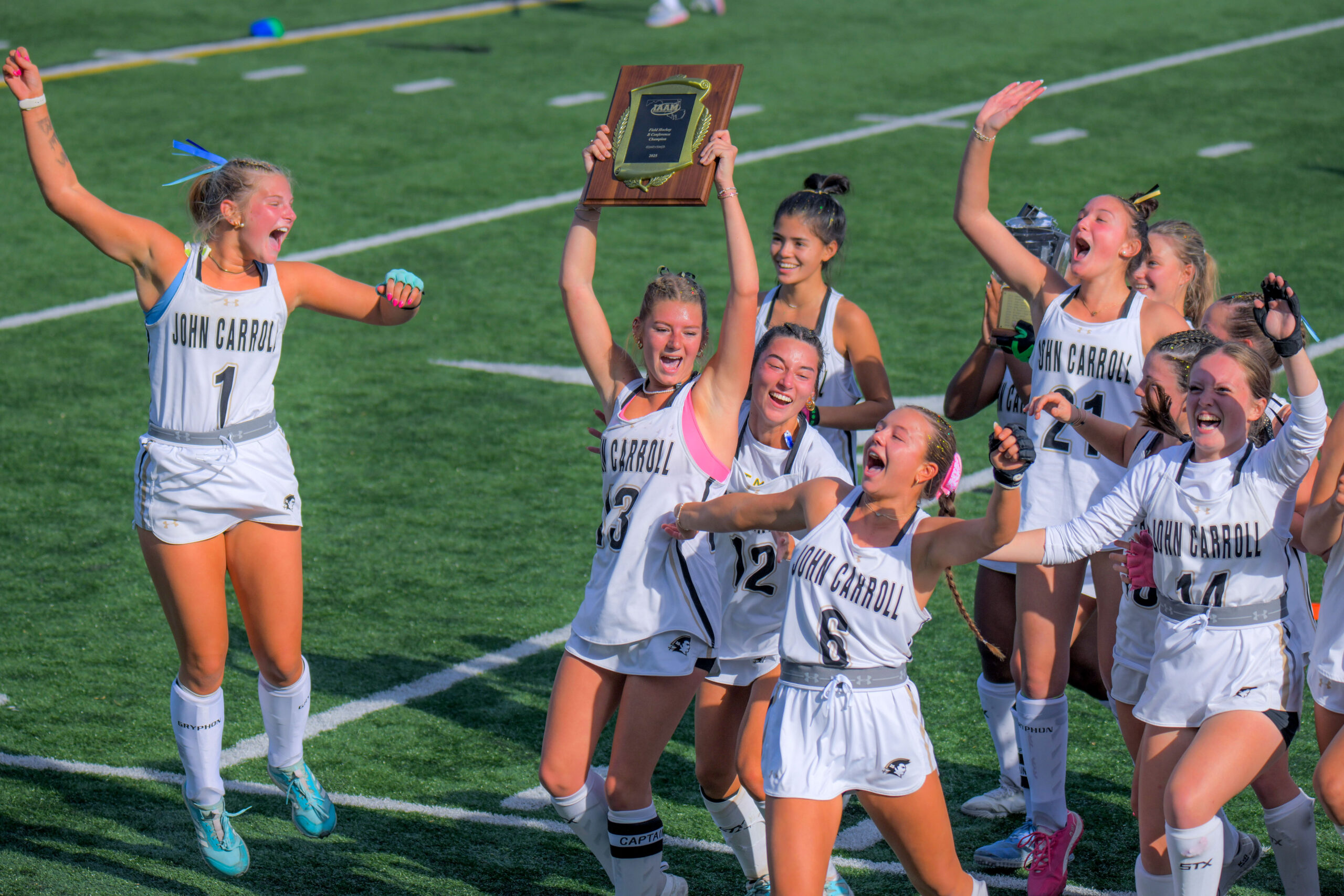 John Carroll field hockey players celebrate the Patriots' IAAM B...