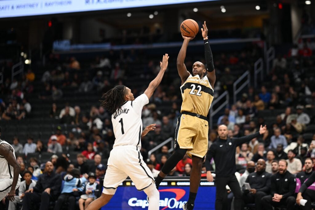 Nov 16, 2025; Washington, District of Columbia, USA; Washington Wizards forward Khris Middleton (22) attempts a jump shot over Brooklyn Nets forward Ziaire Williams (1) during the fourth quarter at Capital One Arena. Mandatory Credit: Rafael Suanes-Imagn Images
