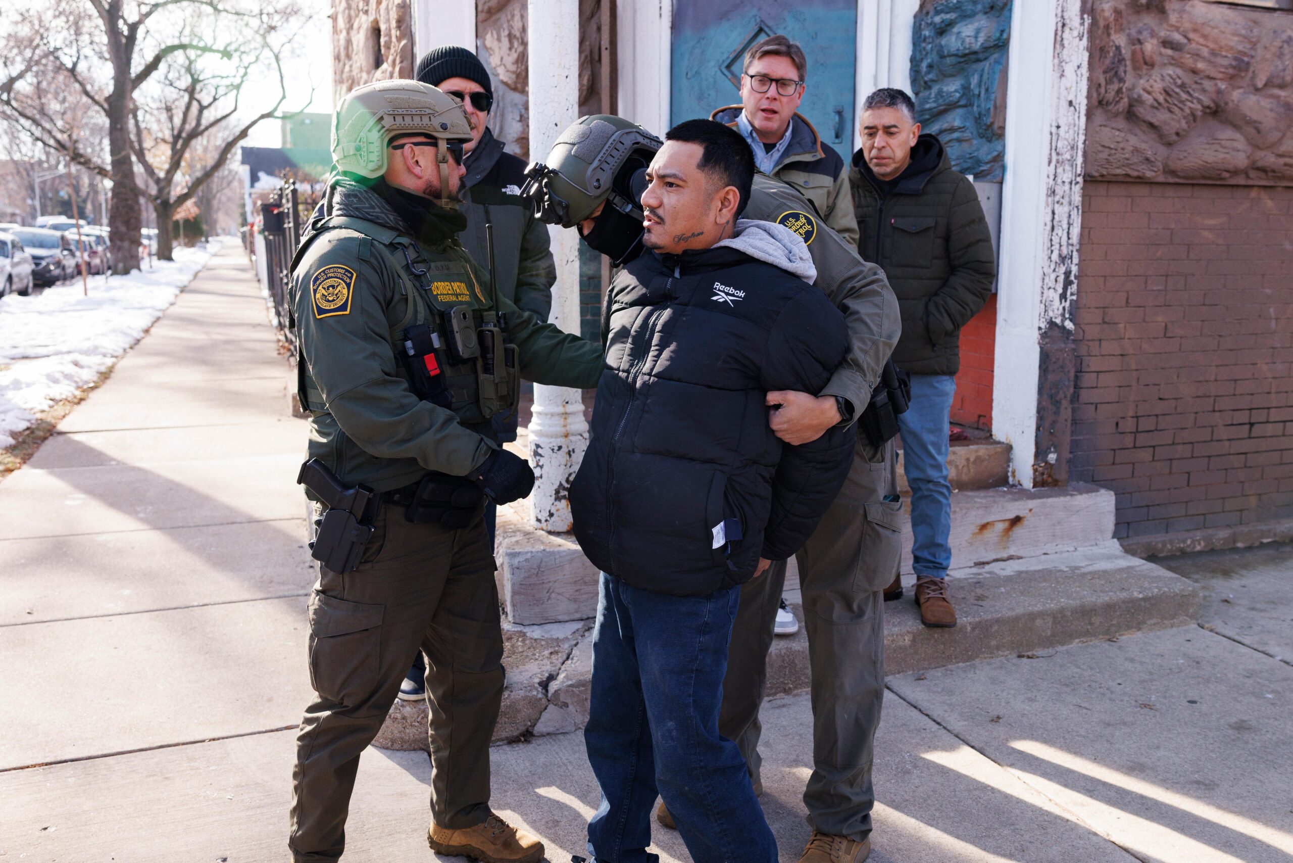 Federal immigration enforcement agents detain an individual near West 27th...