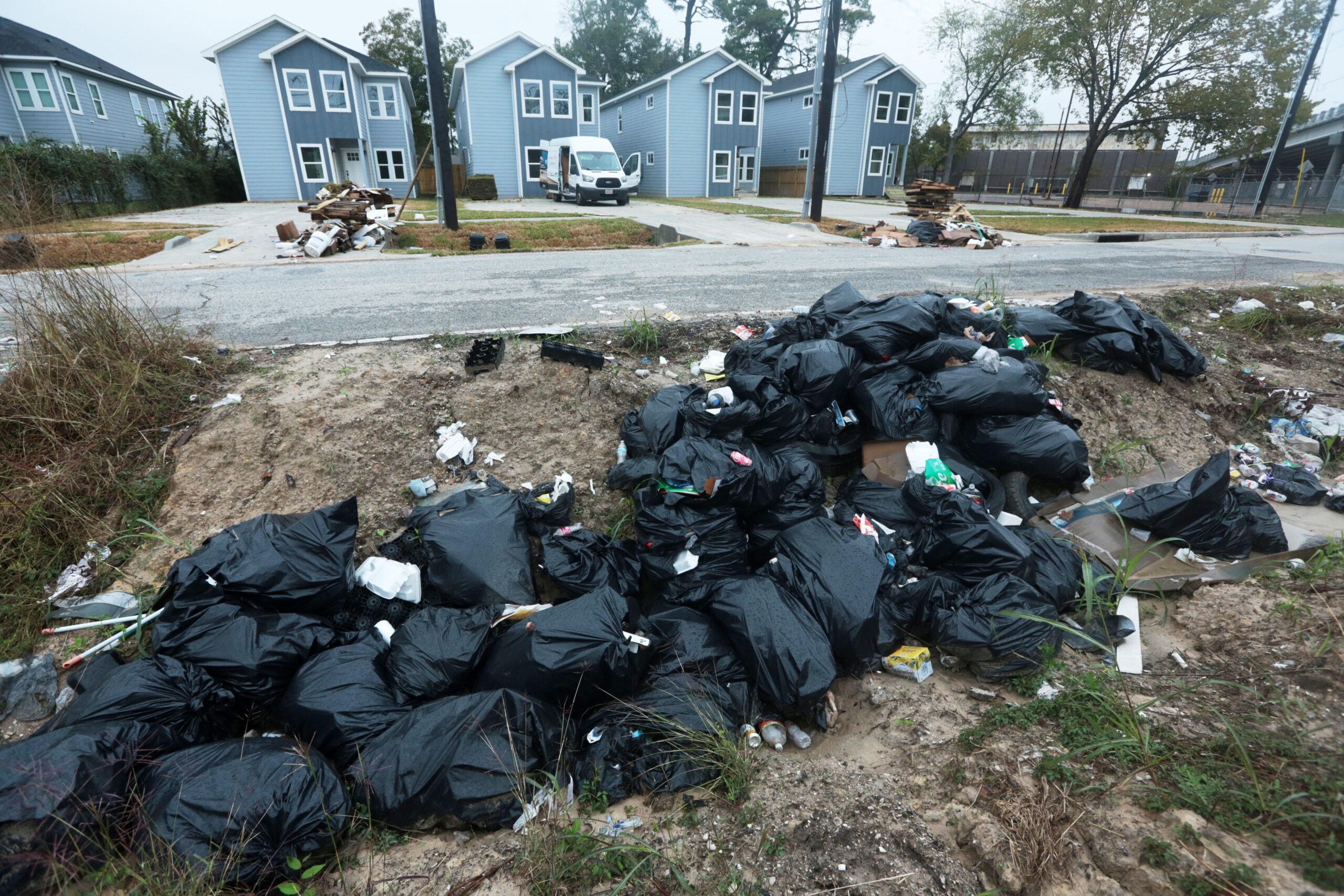 Piles of trash fill the ditch across a construction site...