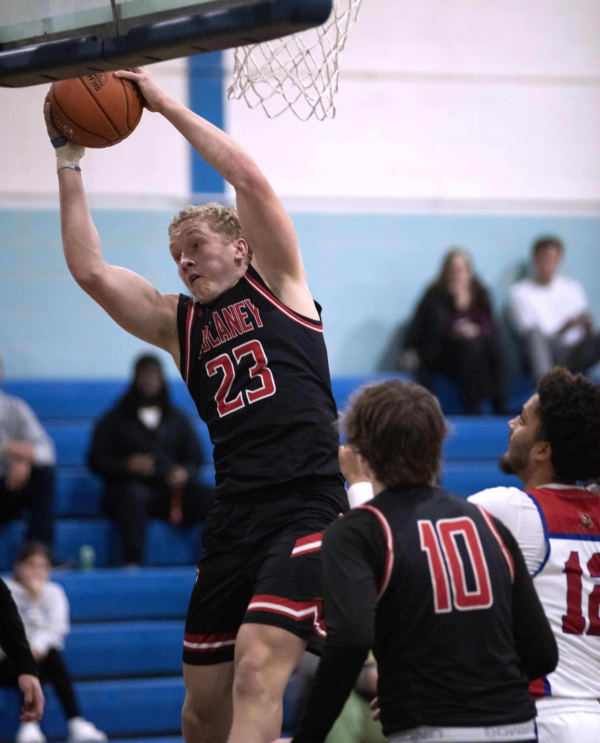 Dulaney's Drew Ranck grabs one of his 17 rebounds in...