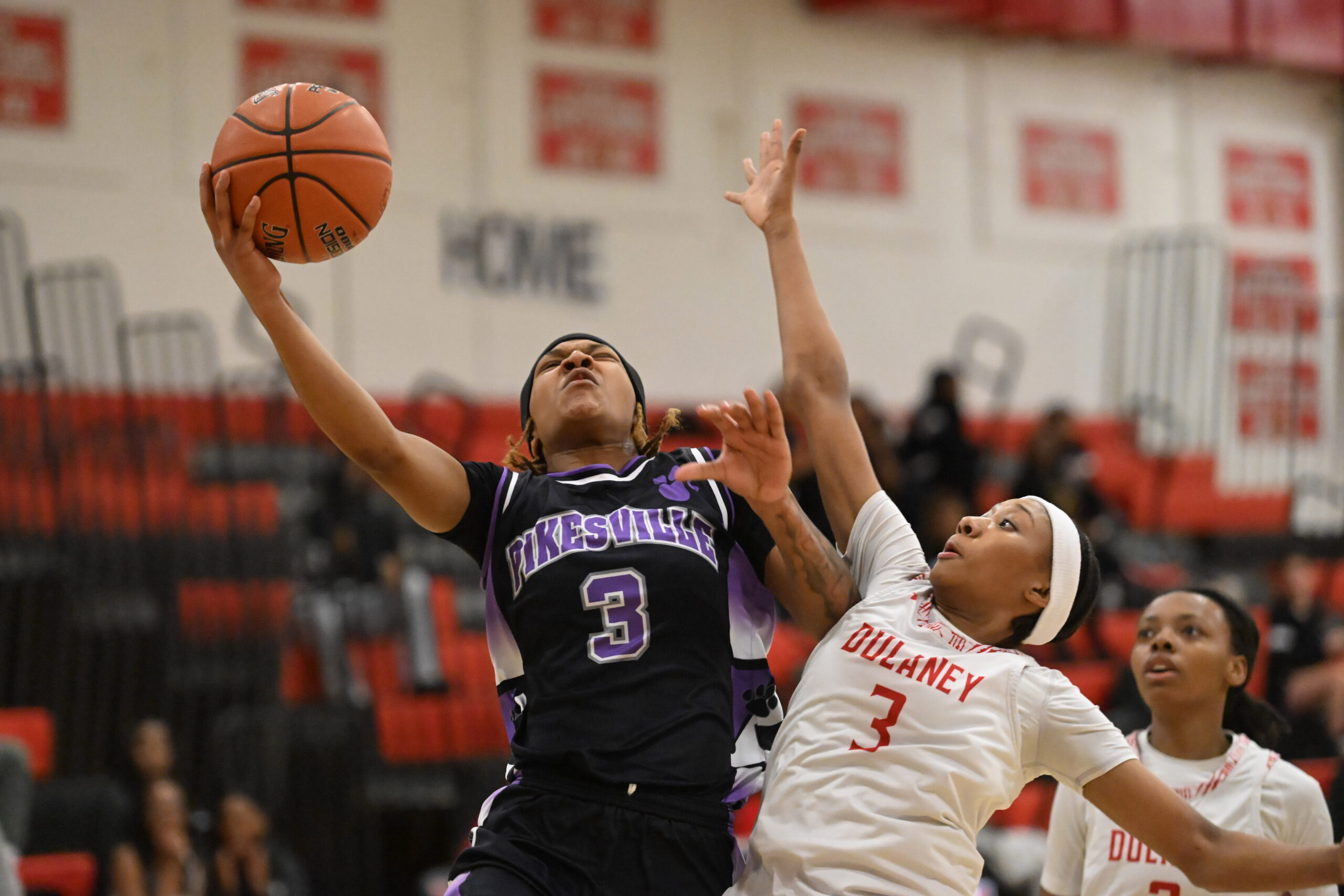 Pikesville's NyJae Malik-El puts up a shot with Dulaney's Gabby...