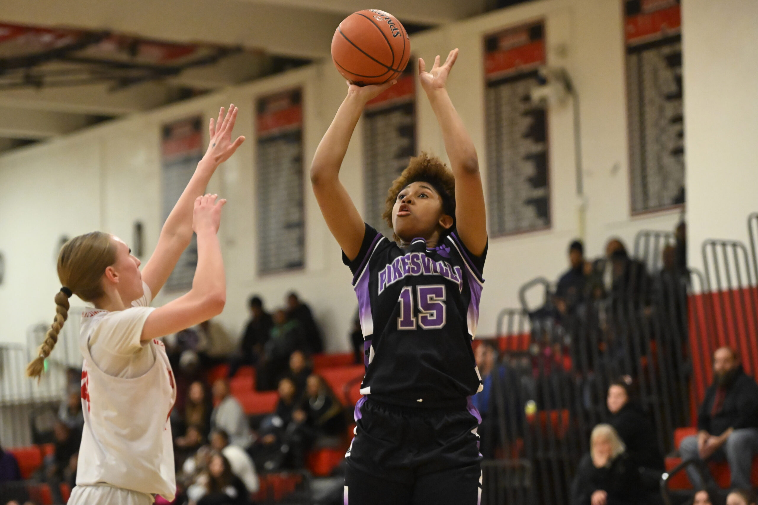 Pikesville's Qaidence David releases a shot over Dulaney's Brenley Graham...