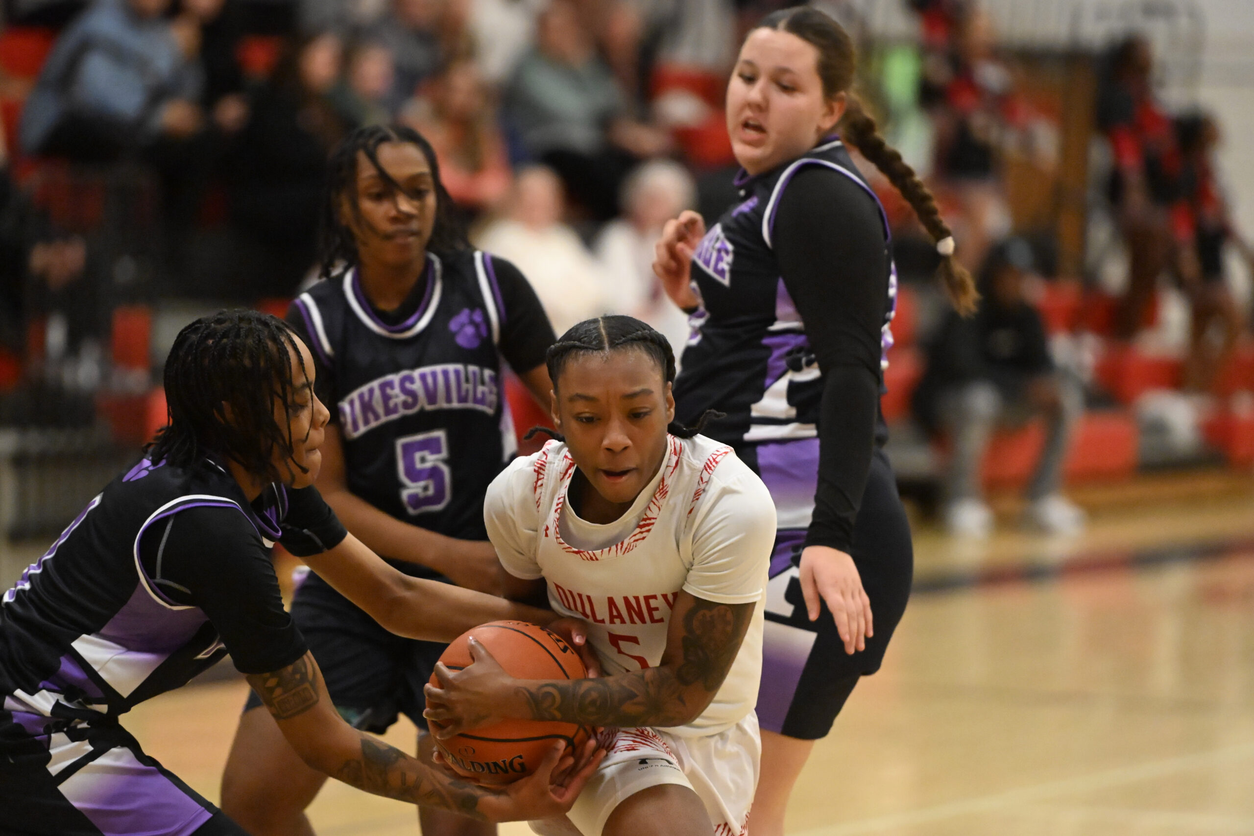 Pikesville's Mariah Jones-Bey, left, makes a move to steal the...