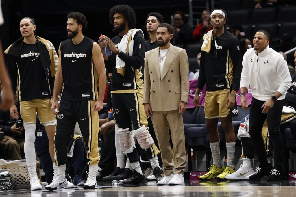  Newly acquired Washington Wizards guard Trae Young (M) looks on from the bench with teammates against the New Orleans Pelicans in the first half at Capital One Arena.