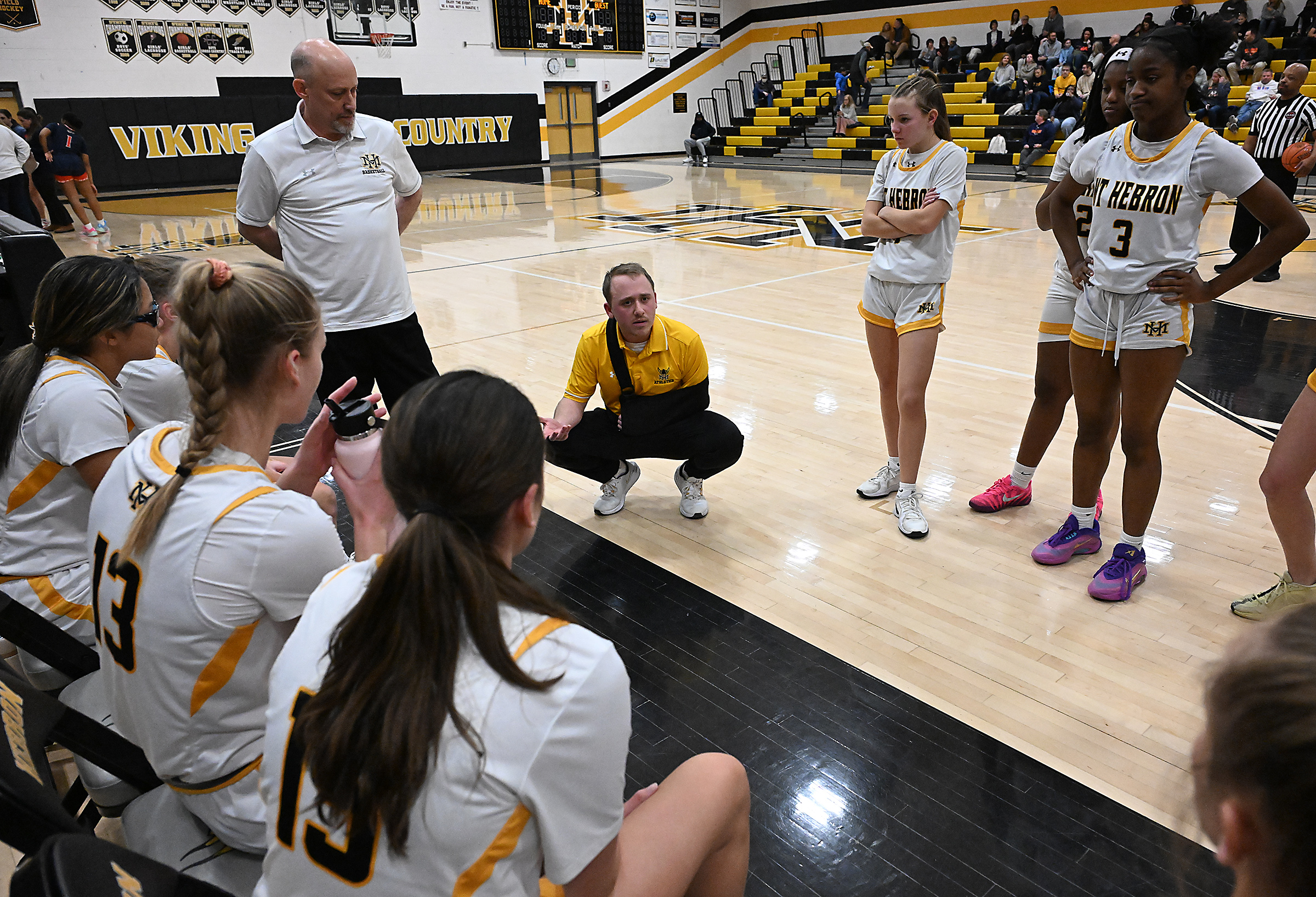 Hebron girls basketball coach, Christopher VanderVat during a timeout in...