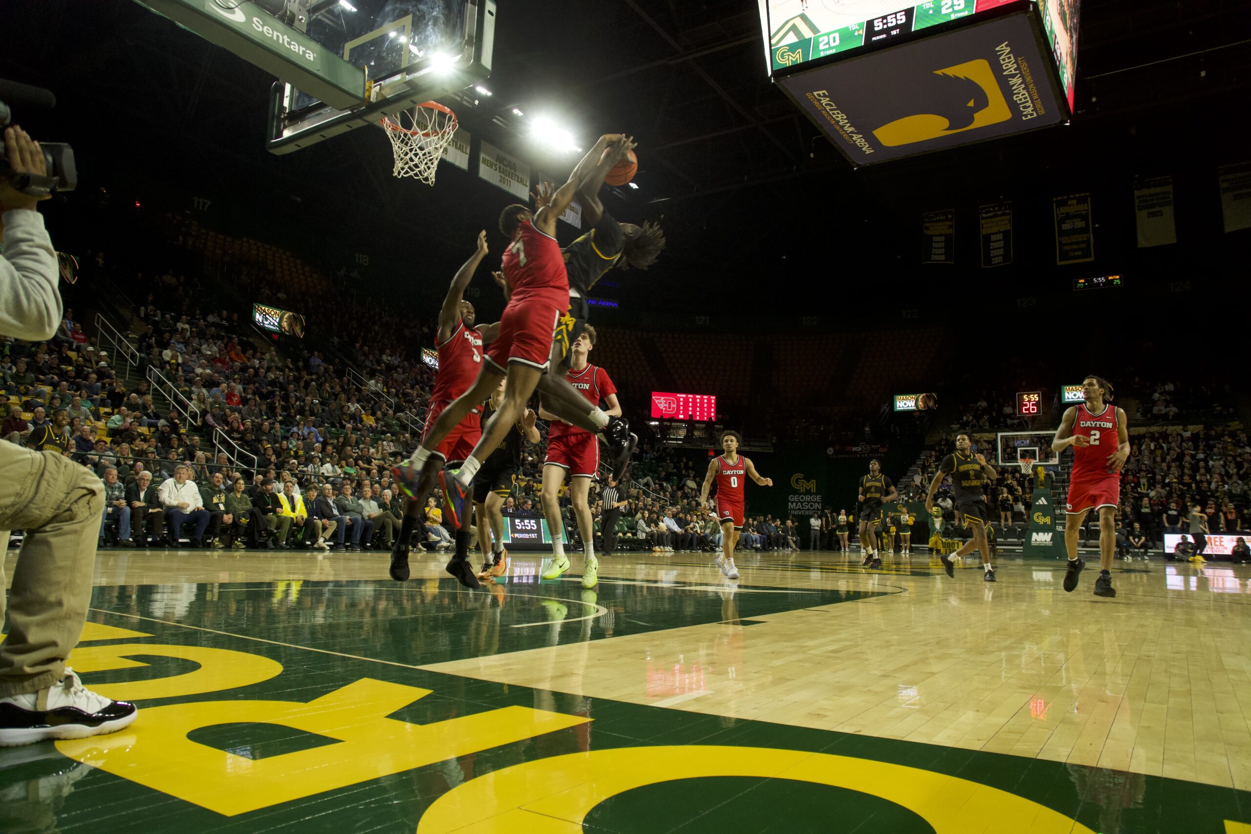 A Patriots player has their attempt on the basket blocked by a Dayton player.